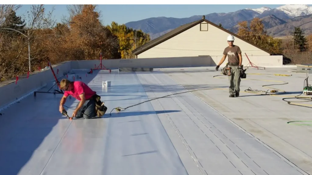 Commercial re-roofing in Tampa FL with workers installing new roofing layer over existing roof