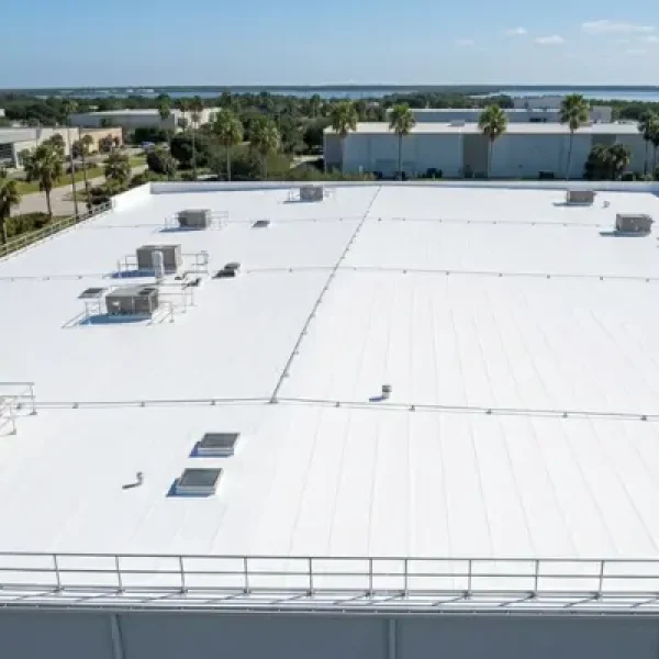 Completed commercial roofing project on a large commercial building showing newly installed roof with clean finish